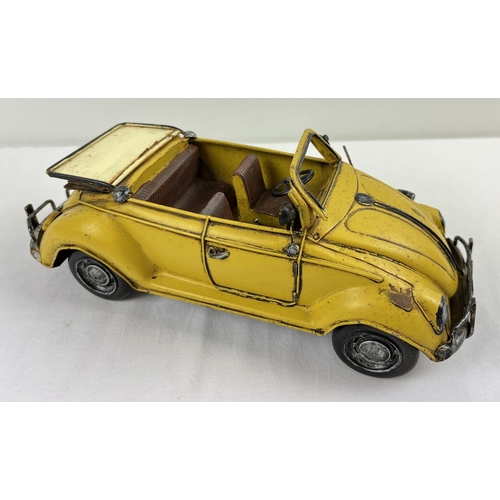 1195 - A tin plate metal model of a yellow Volkswagen convertible car. Approx. 34cm long.