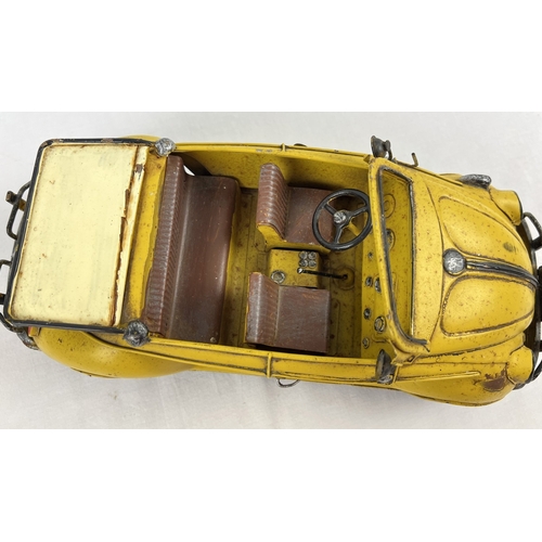 1195 - A tin plate metal model of a yellow Volkswagen convertible car. Approx. 34cm long.