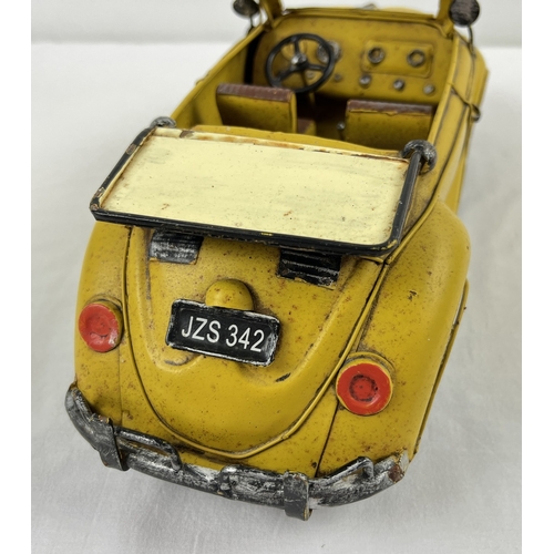 1195 - A tin plate metal model of a yellow Volkswagen convertible car. Approx. 34cm long.