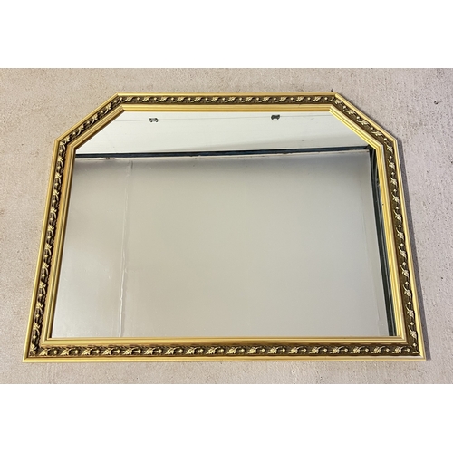 1364 - A large modern gilt framed over mantle mirror with floral designed frame. Approx. 88cm tall x 114cm ... 