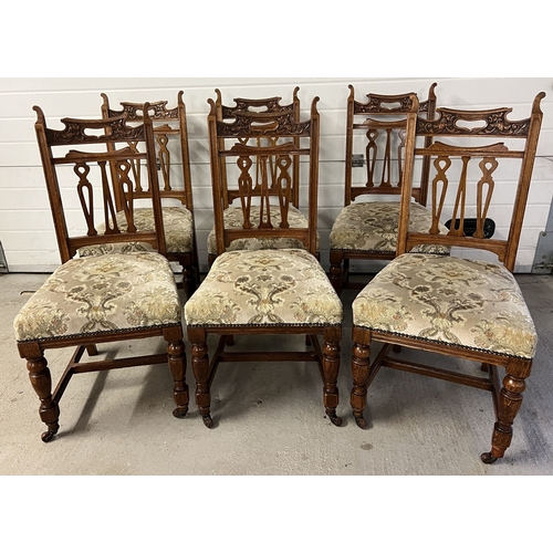 1365 - A set of 6 early 20th century carve backed dining chairs, with original caster front feet and turned... 