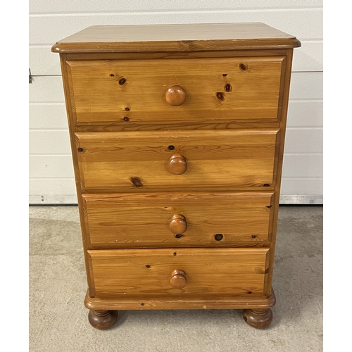 1366 - A small modern pine 4 drawer chest with wooden knob handles and bun feet. Approx. 85cm tall x 58cm w... 