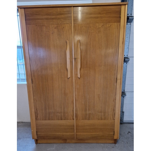 1368 - A mid century teak double wardrobe with moulded handles and complete with key. Interior has hanging ... 