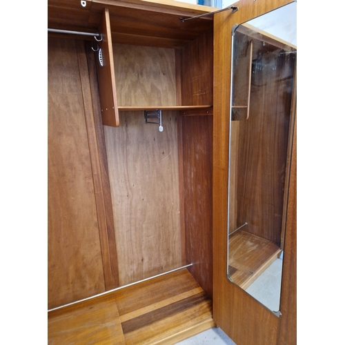 1368 - A mid century teak double wardrobe with moulded handles and complete with key. Interior has hanging ... 