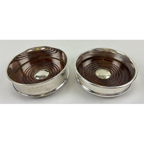 1186 - 2 modern silver plated wine coasters with dark wood bases and green baize to underside. Each approx.... 