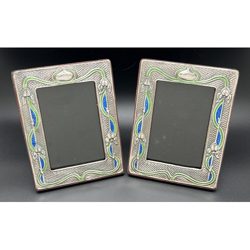 1187 - A pair of Art Nouveau design silver fronted photo frames with green & blue enamelled detail. Each st... 