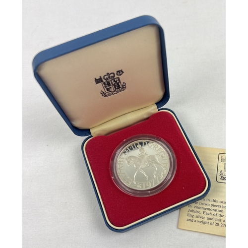 11 - A boxed 1977 Queen Elizabeth II Silver Jubilee silver proof commemorative crown by The Royal Mint. C... 