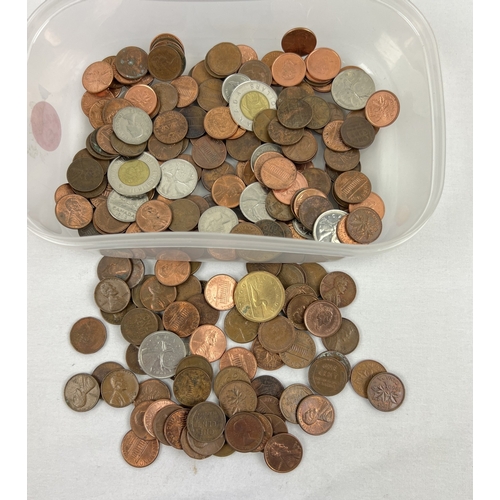 23 - A tub of vintage American and Canadian coins to include mostly 1 cent coins. Lot also includes Canad... 