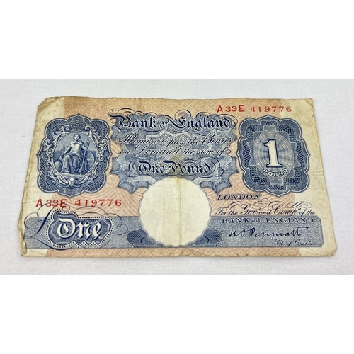 32 - A K.O Peppiatt blue/pink wartime One Pound note, A33E 419776 - the first note to contain an embedded... 
