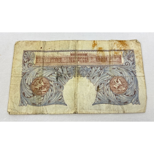 32 - A K.O Peppiatt blue/pink wartime One Pound note, A33E 419776 - the first note to contain an embedded... 