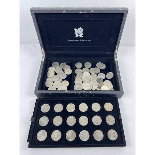 41 - A 2012 London Olympics coin presentation case with lift out tray, containing 76 commemorative crowns... 