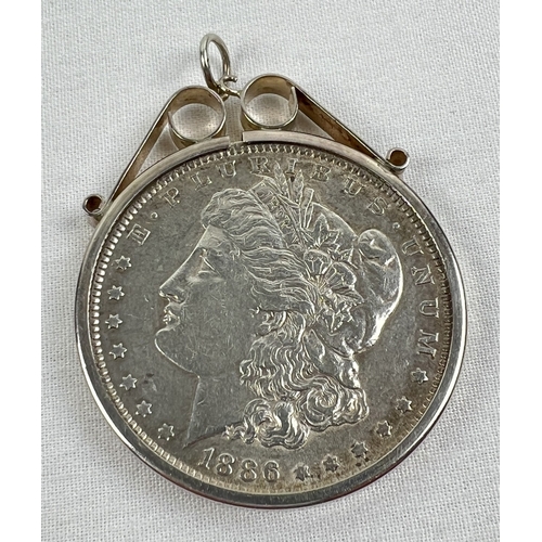 46 - An 1886 silver Morgan Dollar in a decorative silver pendant mount. Total weight including mount appr... 
