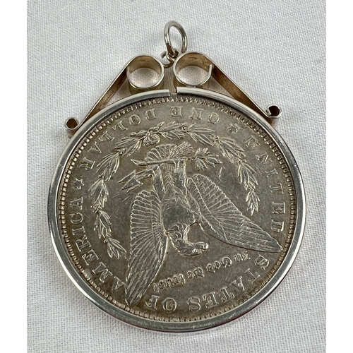 46 - An 1886 silver Morgan Dollar in a decorative silver pendant mount. Total weight including mount appr... 