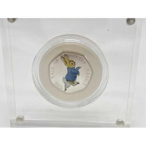 66 - A boxed Beatrix Potter Peter Rabbit 2017 silver proof 50p coin with colour detail to reverse. In pre... 