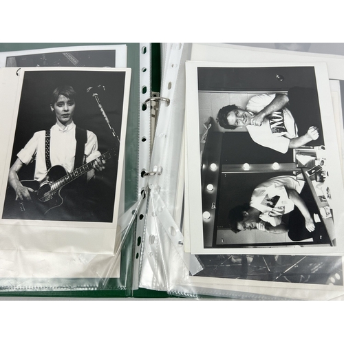 220 - A folder containing 70 professional black & white and Colour photographs of Actors, Musicians and Co... 