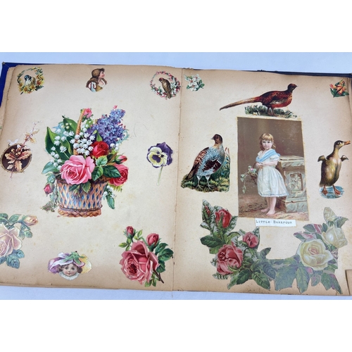 231 - A late Victorian scrap album containing greetings cards, silks and scraps. Album has navy blue cover... 