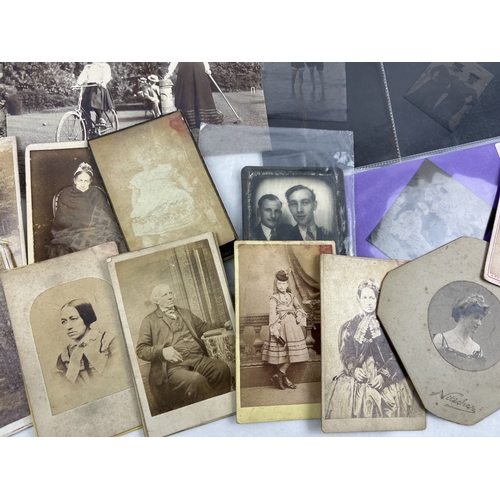 251 - A small collection of Victorian photographs, cabinet cards and tintype photos showing period dress.