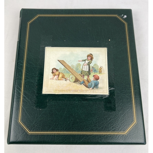 253 - An album containing 165 assorted Victorian & Edwardian greetings cards displayed in clear plastic en... 