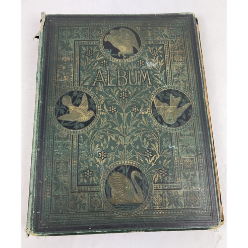 256 - A large dark green Art Nouveau scrap album containing prints, postcards and scraps.