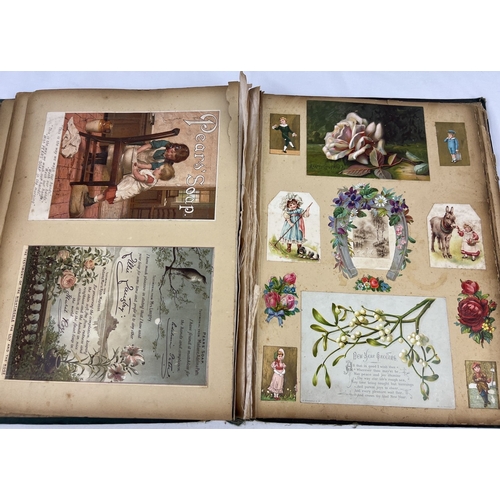 256 - A large dark green Art Nouveau scrap album containing prints, postcards and scraps.