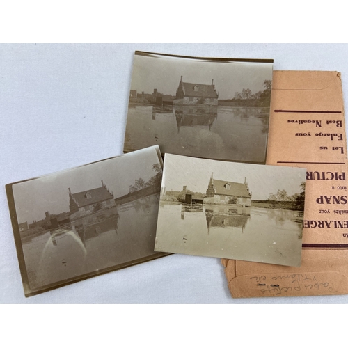 264 - A collection of vintage photographic prints and negatives in paper wallets.