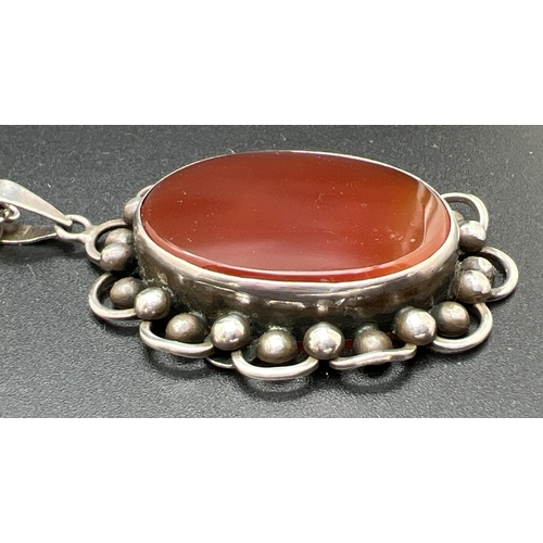 1010 - A vintage continental silver (830) floral design oval pendant set with carnelian, on a 925 silver 24... 