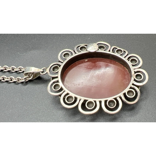 1010 - A vintage continental silver (830) floral design oval pendant set with carnelian, on a 925 silver 24... 