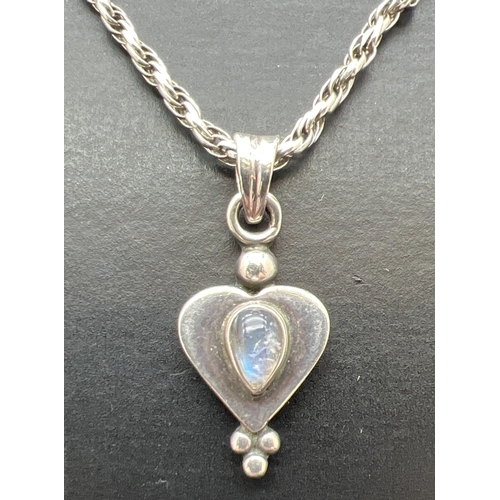 1036 - A silver modern design heart shaped drop pendant set with a cabochon of moonstone. On a 22