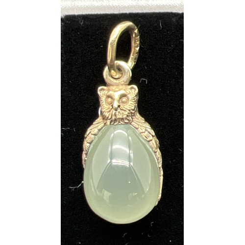 1064 - A pendant modelled as an owl with an egg shaped piece of green jade. Hanging bale tests as 9ct gold,... 