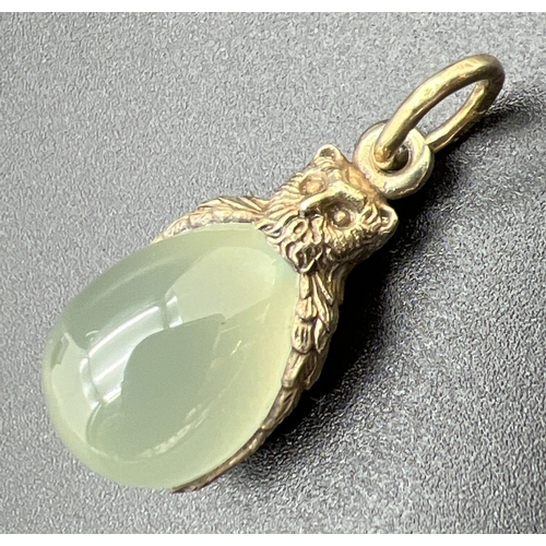 1064 - A pendant modelled as an owl with an egg shaped piece of green jade. Hanging bale tests as 9ct gold,... 