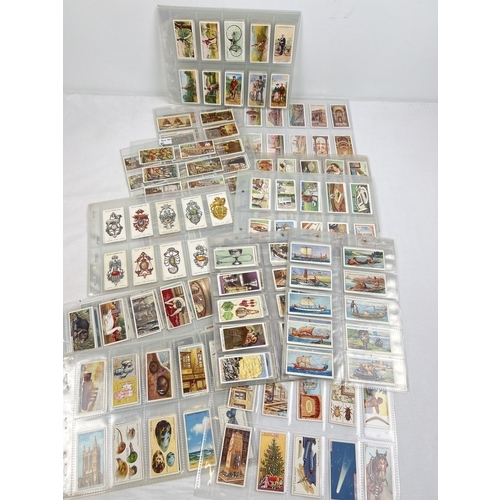 233 - A quantity of assorted Wills, Players & Churchmans cigarette cards, in clear plastic display sleeves... 