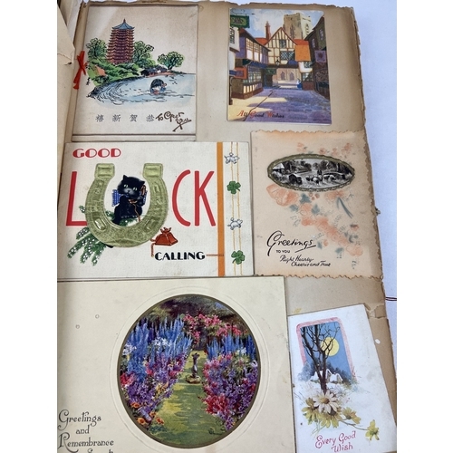 240 - A large Art Deco scrap album containing mostly greetings cards, but also postcards and scraps.