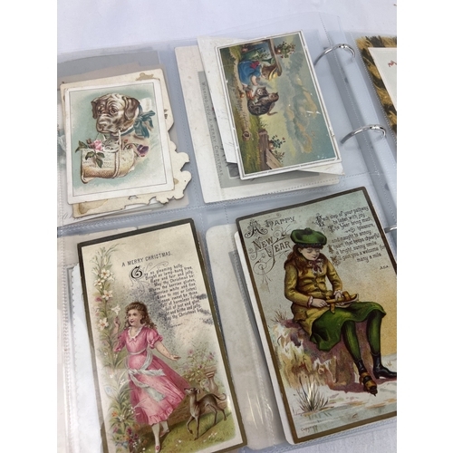 253 - An album containing 165 assorted Victorian & Edwardian greetings cards displayed in clear plastic en... 