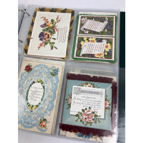 253 - An album containing 165 assorted Victorian & Edwardian greetings cards displayed in clear plastic en... 