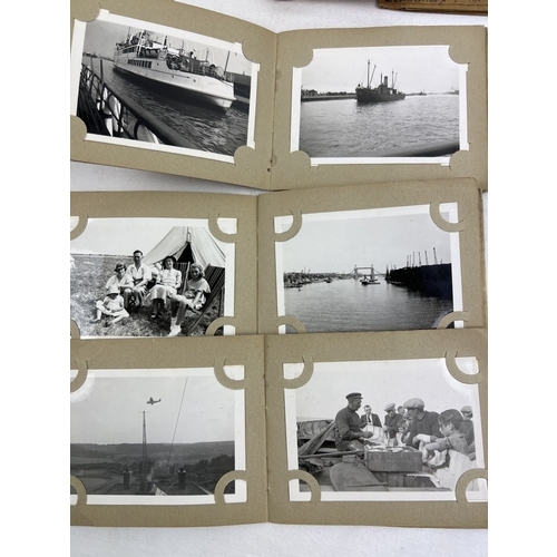 264 - A collection of vintage photographic prints and negatives in paper wallets.