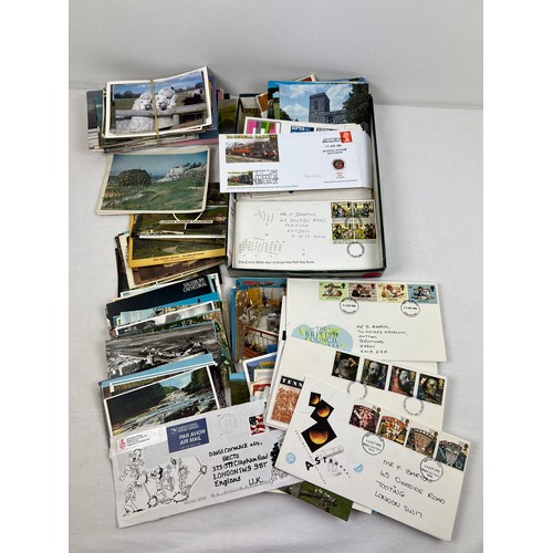 143 - A collection of assorted ephemera, stamps and collectable coin, to include postcards, first day cove... 