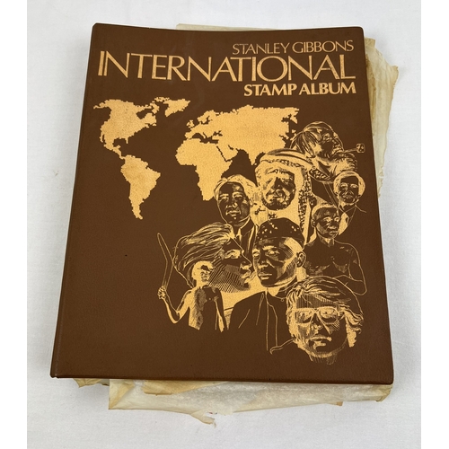 146 - A brown vintage Stanley Gibbons International Stamp Album containing antique and vintage staps from ... 