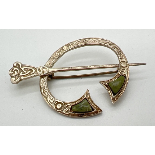 1049 - A vintage Irish silver Celtic style brooch set with natural green agate. Silver marks to reverse. Ap... 