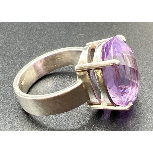 1054 - A modern design silver dress ring set with a checkerboard cut oval amethyst, stone approx. 1.75cm x ... 