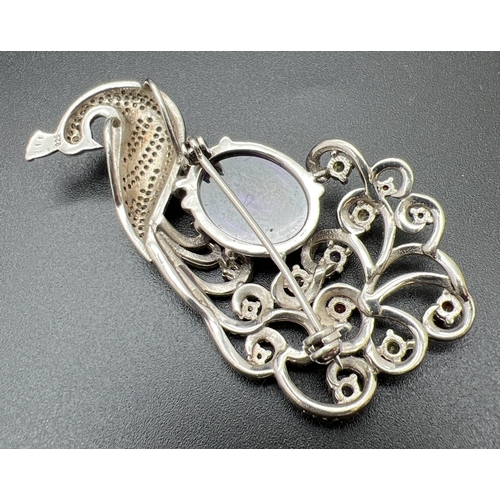 1068 - A large silver stone set pendant brooch modelled as a peacock, with large oval shaped purple cabocho... 