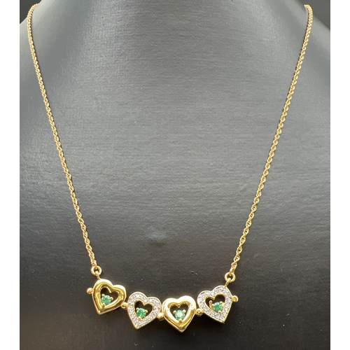 1074 - A Bradford Exchange gold plated fixed pendant necklace set with emeralds & cubic zirconia's. Pendant... 