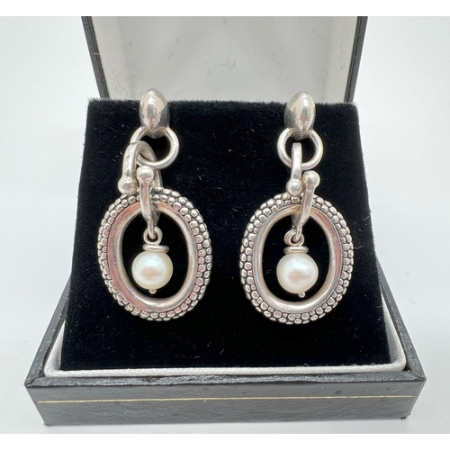 1099 - A pair of silver, 14ct gold and pearl drop earrings by Michael Dawkins. Round white single pearl sus... 