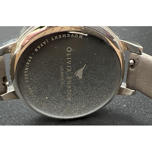 1108 - A ladies wristwatch with grey leather strap and floral design face (OBO52) by Olivia Burton. Stainle... 