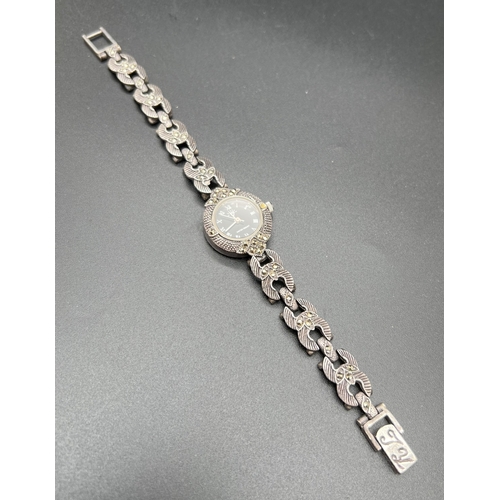 1109 - A ladies silver cocktail watch with floral detail and 3 marcasite stones to each links. Engine turne... 