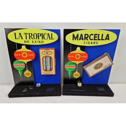 2 vintage freestanding Christmas shop display units for cigars - La Tropical De Luxe and Marcella Cigars. Each with a display packet of cigars attached. Approx. 28cm/11" tall.