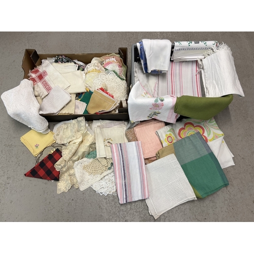 1327 - 2 boxes of assorted vintage table cloths and table linen to include doilies and tray cloths.