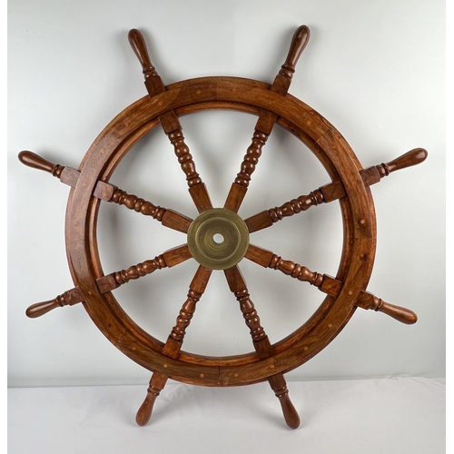 1341 - A large wooden ships wheel with brass centre and turned spokes. Approx. 92cm diameter.