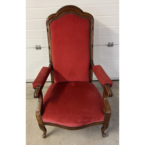 1368 - A large antique shaped high back low armchair with red corduroy velvet upholstery. Peg holes evident... 