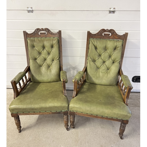 1376 - A pair of Edwardian dark wood framed button backed armchairs with green faux leather upholstery. Rai... 