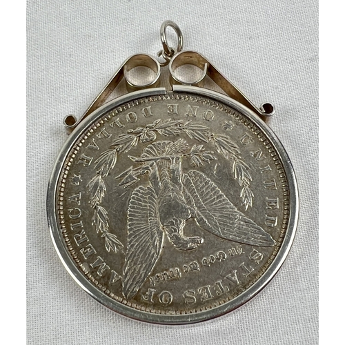 1090 - An 1886 silver Morgan Dollar in a decorative silver pendant mount. Total weight including mount appr... 